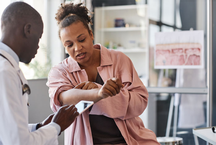 Dermatologist examining a patient